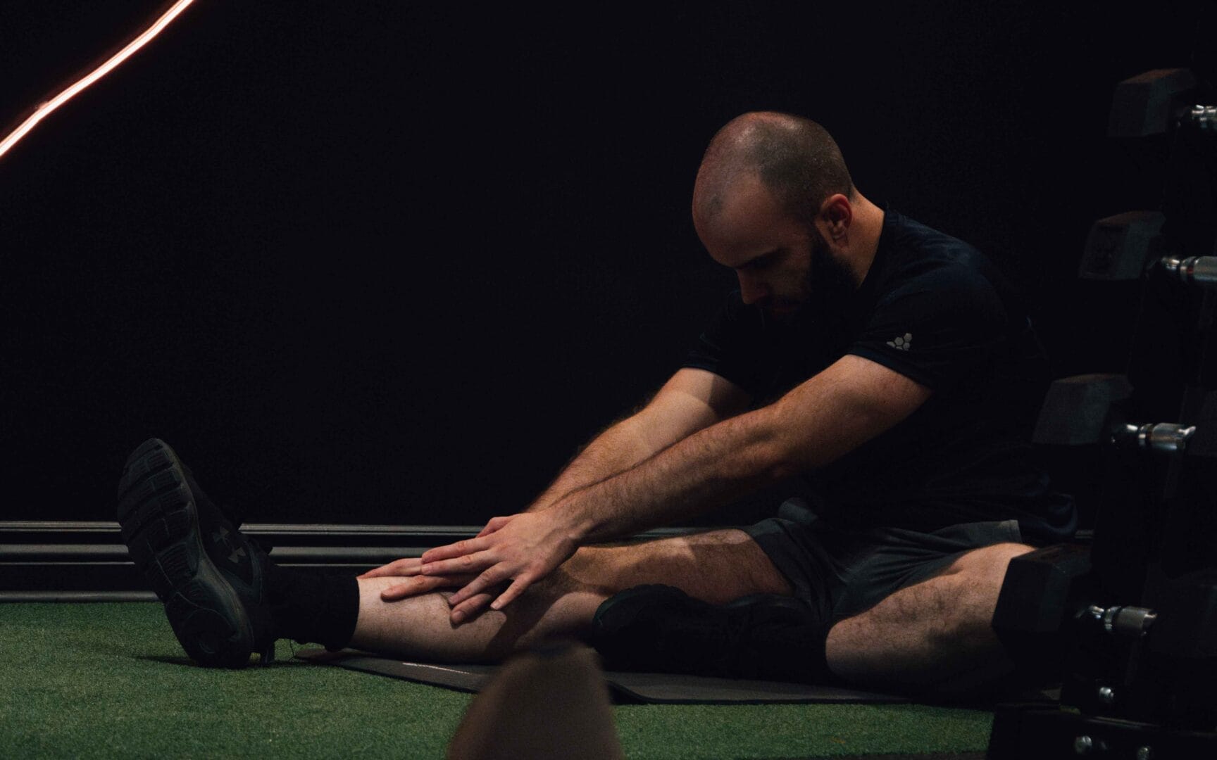 Un coach sportif privé montre les mouvements à faire sur une machine