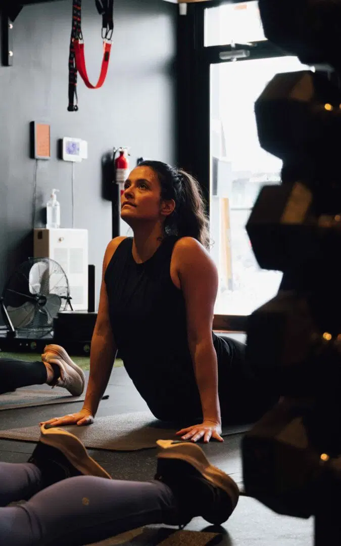 An athletic woman stretching after a session